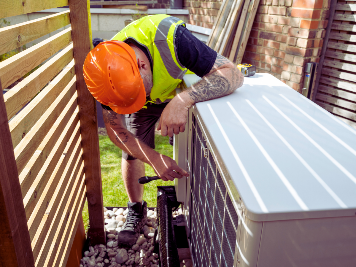 hvac tech performing routine heat pump maintenance 