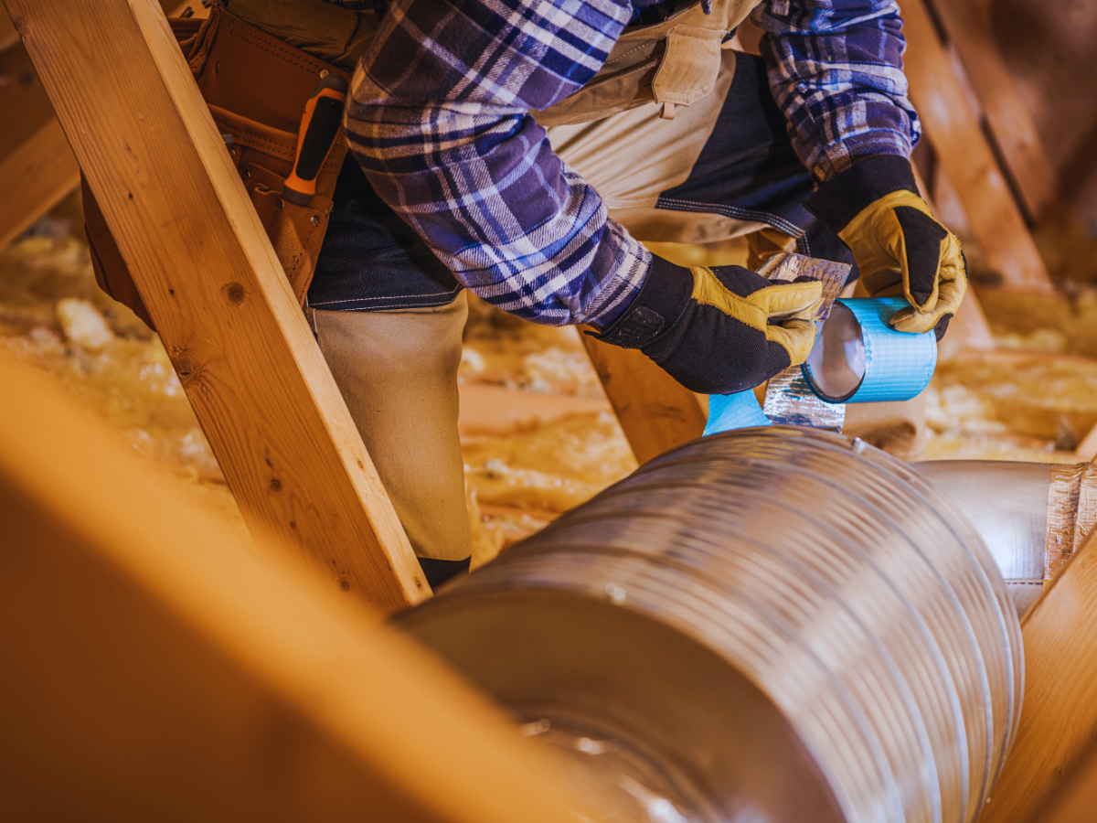 HVAC tech making air duct repairs