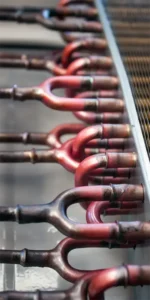 Closeup of a heat exchanger's copper and metal tubing that is used in an HVAC system