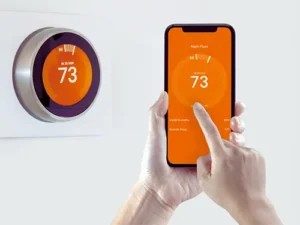 A smart phone being operated by an Orlando FL homeowner as they adjust the thermostat from its app